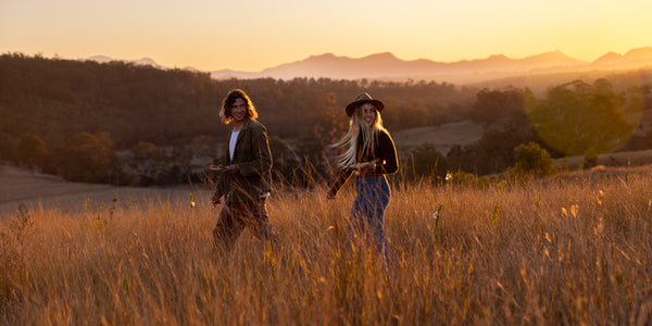 Interwiew Couple walking through the countryside at sunset